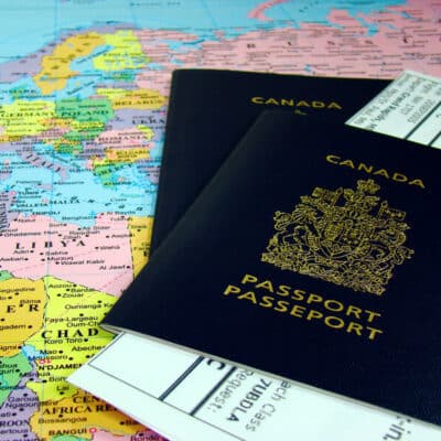 canada passport on top of a map