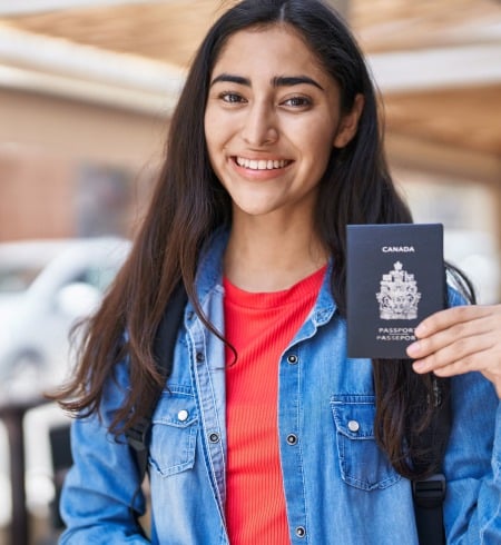 young teenager girl holding canada passport