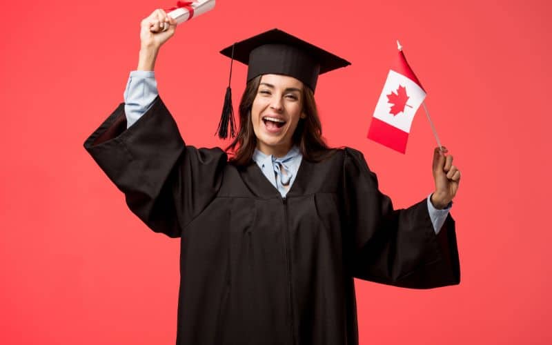 female student academic gown holding-canadian-flag diploma isolated living