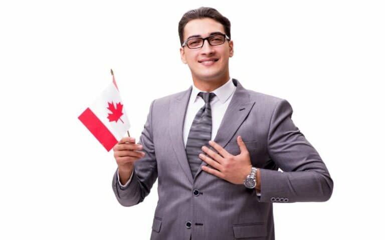 Young Businessman Holding Canadian Flag - Business Immigration