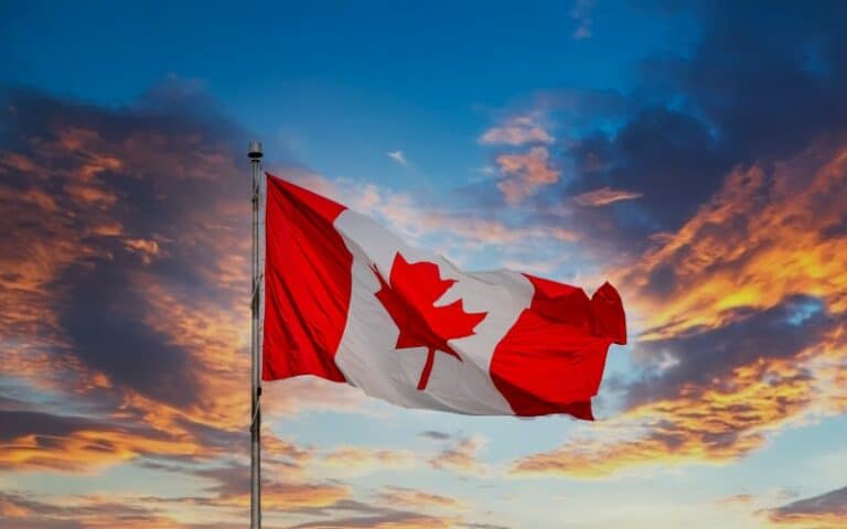 Canadian Flag Flying at Sunset - Canada Immigration