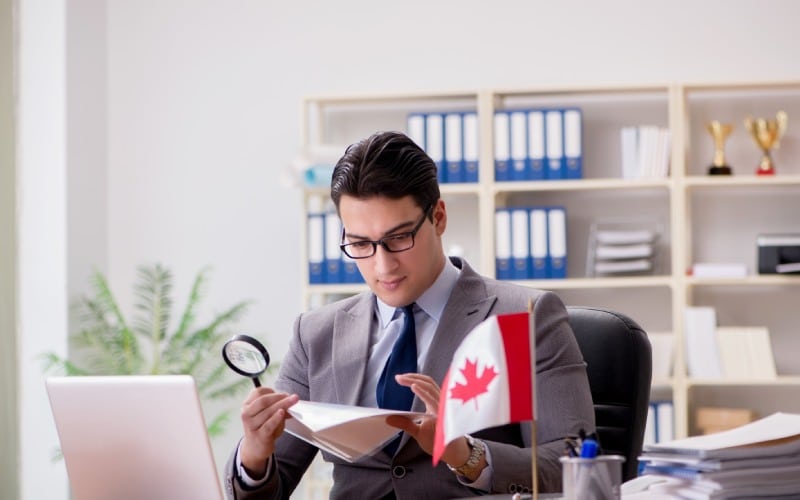 businessman with canadian flag in office